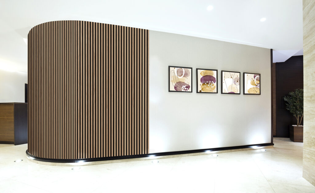 Modern Room with Half Round Half Square Column in the Middle Featuring Light Series Light Oak FibroTech Acoustic Panels