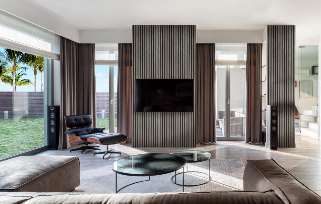 Modern Living Room with Glass Doors Looking at a Garden Featuring Stone Series Concrete FibroTech Acoustic Panels