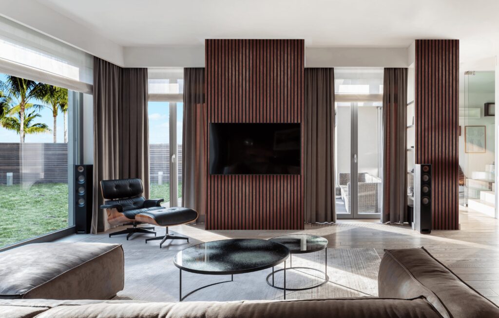 Modern Living Room with Glass Doors Looking at a Garden Featuring Stone Series Rusty FibroTech Acoustic Panels